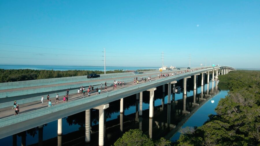 a bridge over a river with people walking on it