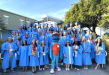COLLEGE OF THE FLORIDA KEYS’ FALL 2025 GRADUATES SECURE DIPLOMAS a group of people in blue graduation gowns posing for a picture
