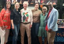 COLLEGE HOLIDAY PARTY COLLECTS HUNDREDS OF TOYS a group of people standing next to each other