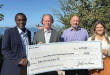 COLLEGE RECEIVES $80K FOR NEW NURSING SCHOLARSHIP a group of people standing next to each other holding a large check