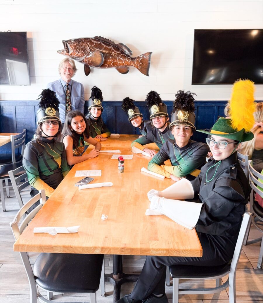a group of people sitting around a wooden table