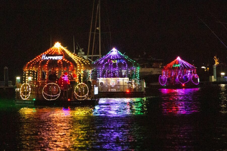 a group of boats with christmas lights on them