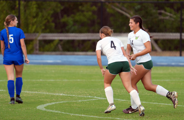 a group of young women playing a game of soccer