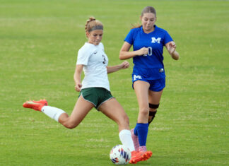 KEYS SOCCER SQUADS LOOK FOR MOMENTUM two girls are playing soccer on a field