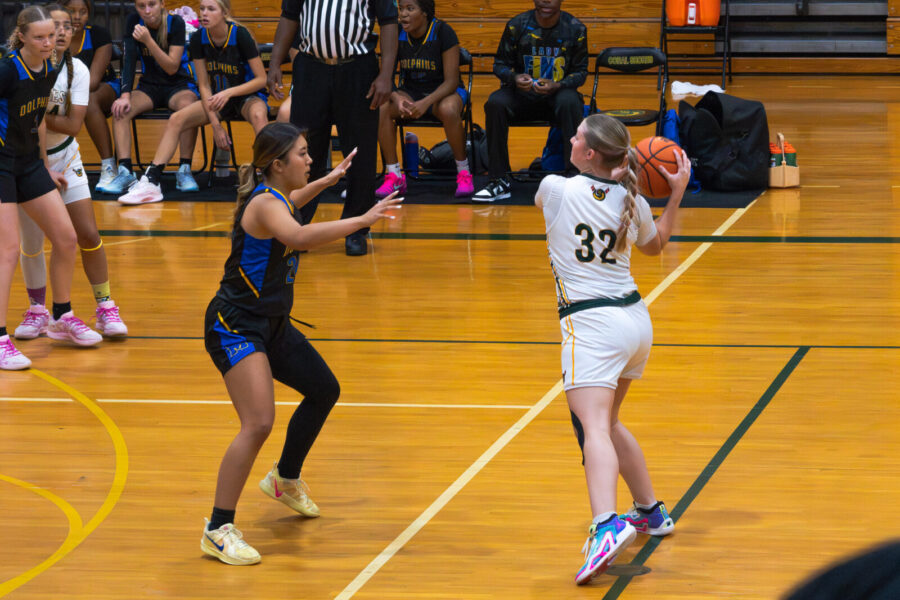 a group of young women playing a game of basketball