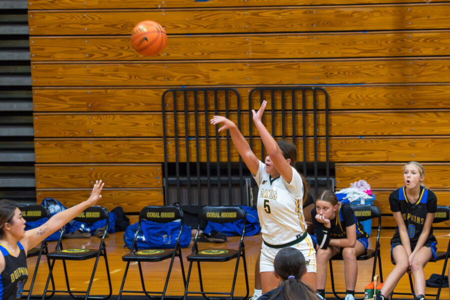 a group of girls playing a game of basketball