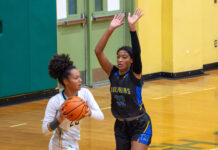 HOOPS RIVALRIES HEAT UP AS TEAMS TRADE EARLY-SEASON BLOWS two girls playing basketball in a gym