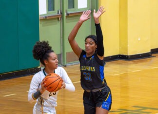 HOOPS RIVALRIES HEAT UP AS TEAMS TRADE EARLY-SEASON BLOWS two girls playing basketball in a gym