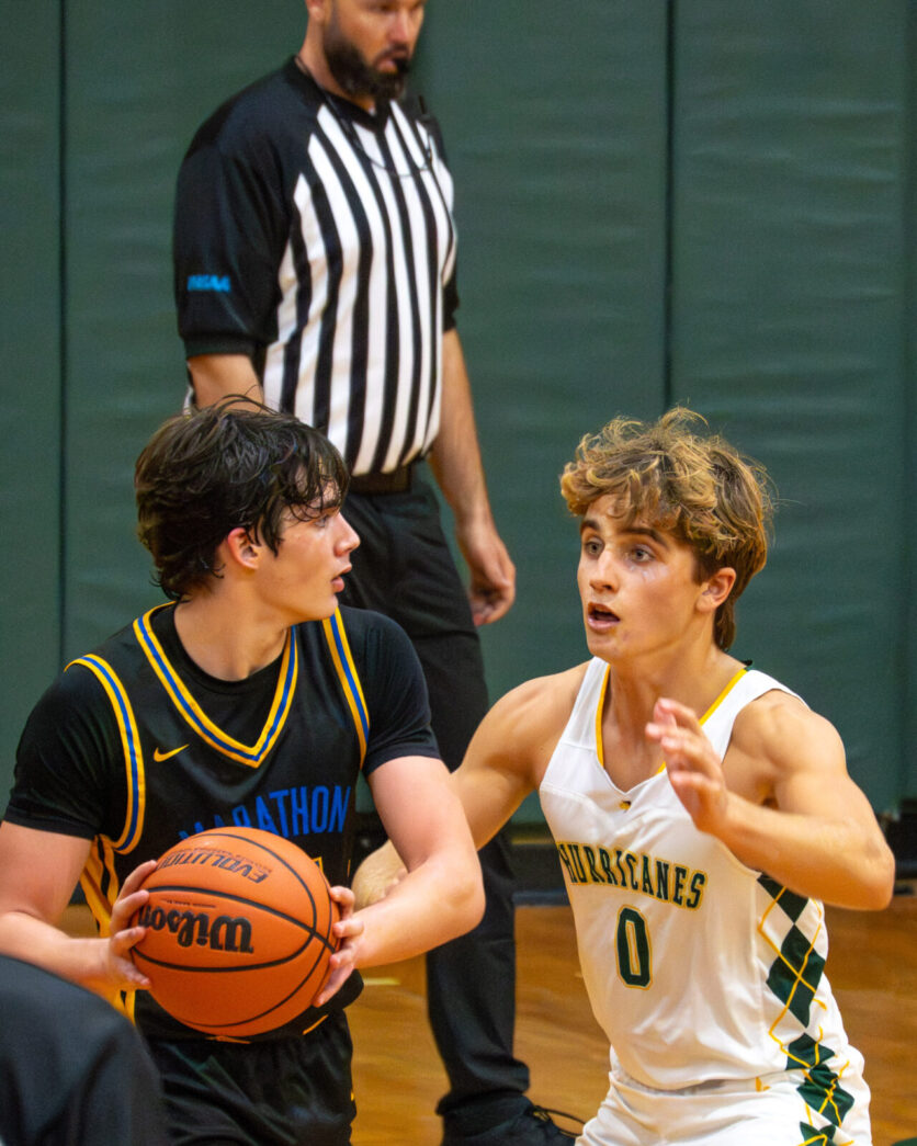 a group of young men playing a game of basketball