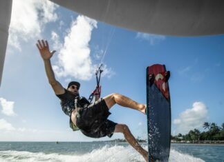 a man riding a wake board on top of a body of water