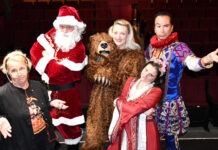 RED BARN THEATRE’S HOLIDAY COMEDY BLENDS SHAKESPEARE WITH DICKENS a group of people dressed up as santa claus