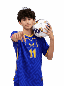 a young man is holding a soccer ball