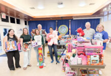a group of people standing in front of a display of toys
