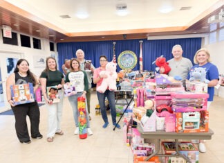 a group of people standing in front of a display of toys