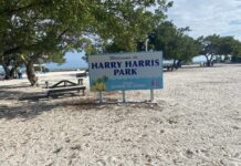 a sign that is sitting in the sand