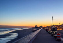 WILD THINGS: ‘DOWN THE SHORE EVERYTHING’S ALL RIGHT’ a view of a beach at sunset from a boardwalk