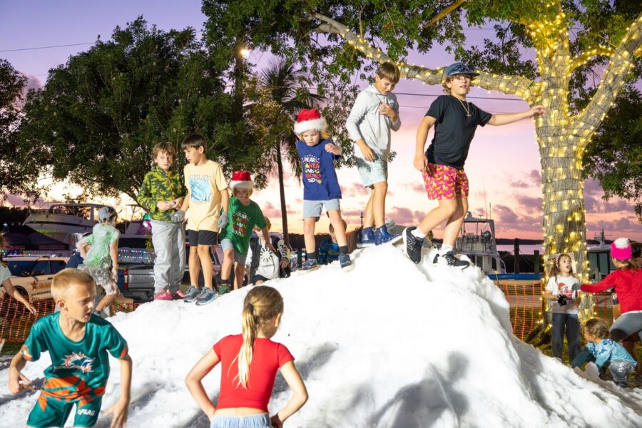 a group of people standing on top of a pile of snow