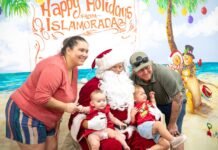 a group of people posing for a picture with a santa clause