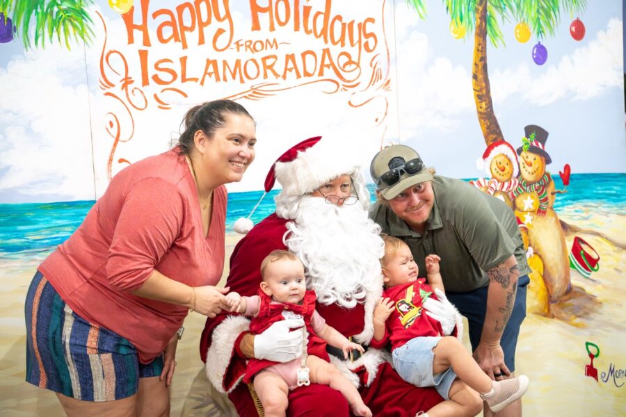 a group of people posing for a picture with a santa clause