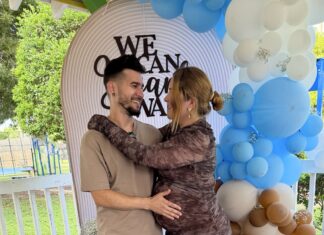 ‘HAVE YOU SUFFERED ENOUGH YET?’ MARATHON MOTHER GIVES BIRTH ALONE AFTER ICE DETAINS HER HUSBAND a man and a woman are hugging under a balloon arch
