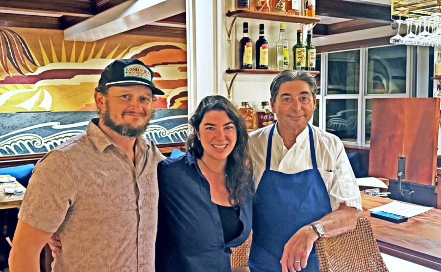 a group of people standing next to each other in a kitchen