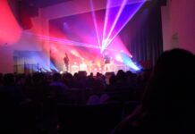 a group of people on a stage with bright lights