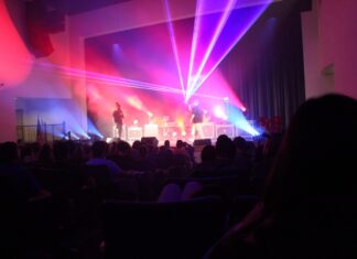 a group of people on a stage with bright lights