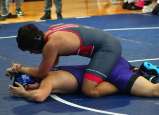 TRIO OF CONCH WRESTLERS GO UNDEFEATED AT BEAR DOWN DUALS a wrestling player is on the ground with his opponent