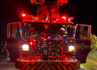 SANTA’S COMING TO MARATHON: SEE THE BIG MAN ON CHRISTMAS EVE AT THESE CARAVAN STOPS a fire truck with lights on driving down a road