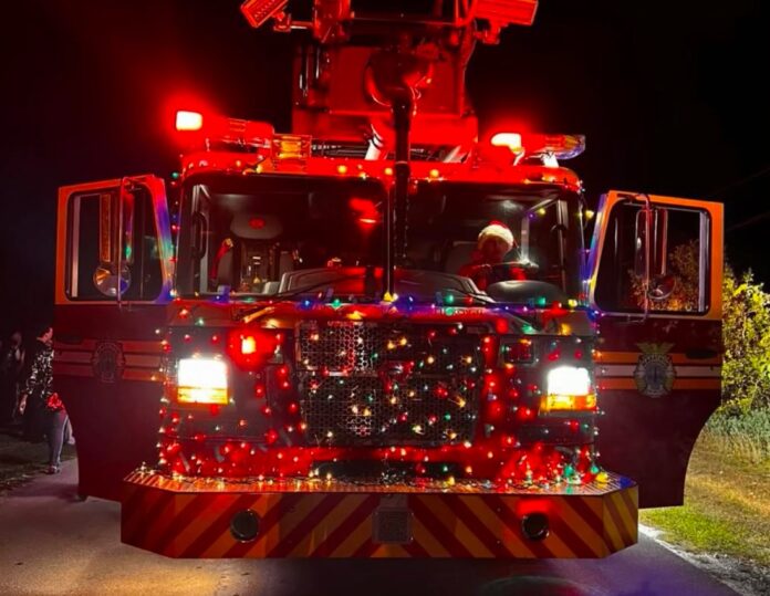 IMG_6831 a fire truck with lights on driving down a road