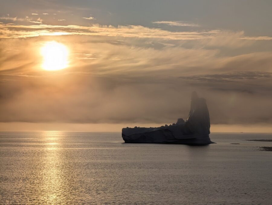 a large iceberg floating on top of a body of water