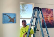 RECEPTION SET FOR ISLAMORADA’S FIRST ART IN PUBLIC PLACES PROGRAM a man standing next to a ladder in a room