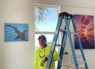 RECEPTION SET FOR ISLAMORADA’S FIRST ART IN PUBLIC PLACES PROGRAM a man standing next to a ladder in a room