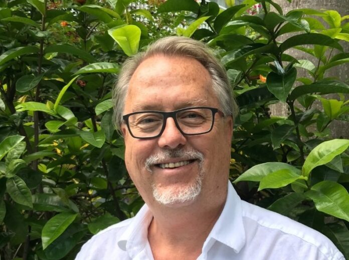 a man wearing glasses and a white shirt