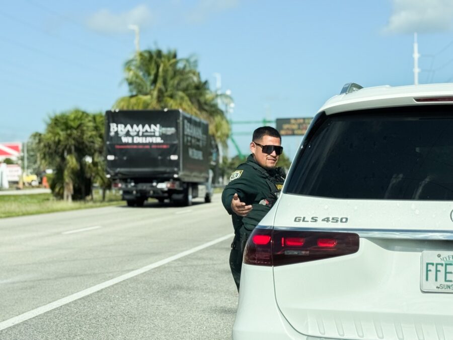 a police officer standing next to a white car