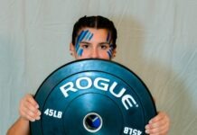 IRON MAIDENS: KEYS’ STRONGEST LADY LIFTERS SHINE AS POSTSEASON NEARS a man holding a blue plate with the word roug on it