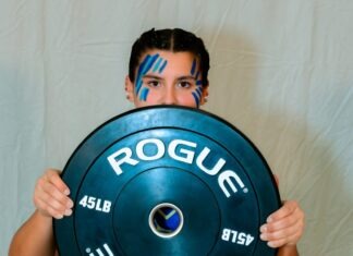 IRON MAIDENS: KEYS’ STRONGEST LADY LIFTERS SHINE AS POSTSEASON NEARS a man holding a blue plate with the word roug on it