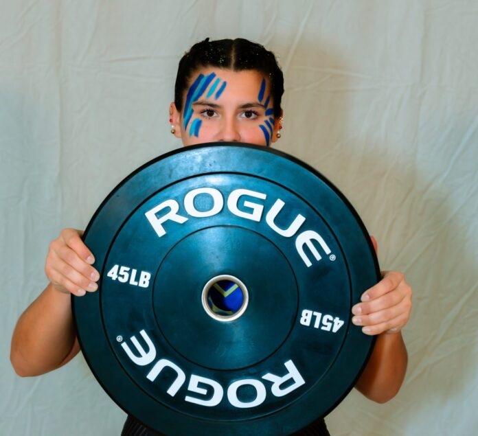 a man holding a blue plate with the word roug on it