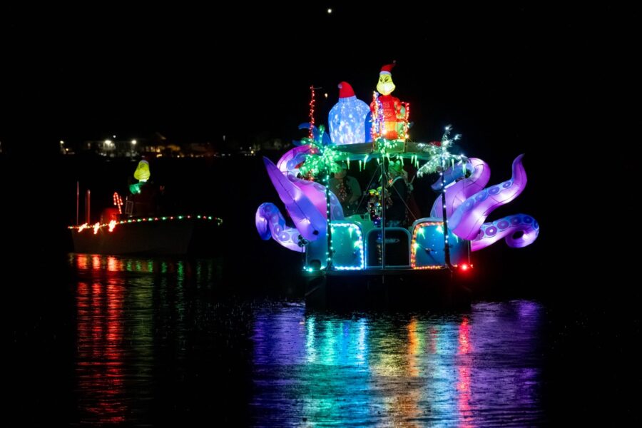 a boat decorated with lights on the water