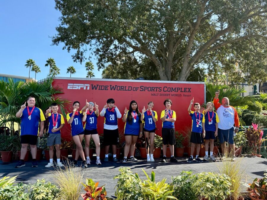 a group of people that are standing in front of a sign
