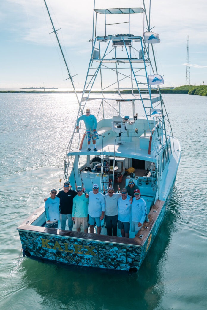 a group of people standing on a boat in the water