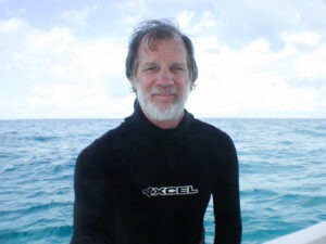 a man standing on a boat in the ocean