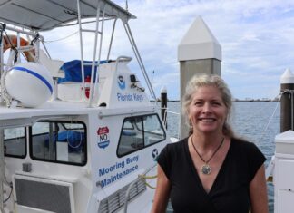 KEYS MARINE SANCTUARY’S LAVERDURE NAMED EMPLOYEE OF THE YEAR a woman standing on a dock next to a boat