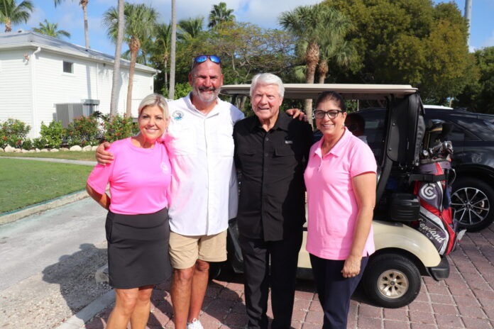 a group of people standing in front of a golf cart