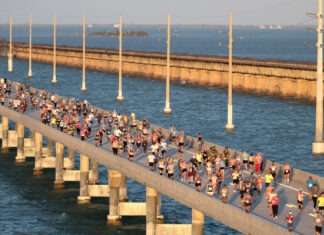a large group of people running across a bridge