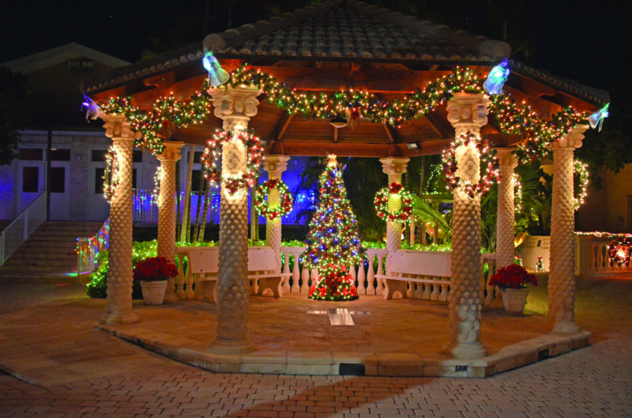 a gazebo decorated with christmas lights and decorations