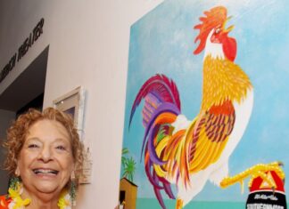 MEET MARSHA WILLIAMS: EMBRACING THE ART OF VOLUNTEERING a woman standing in front of a painting of a rooster