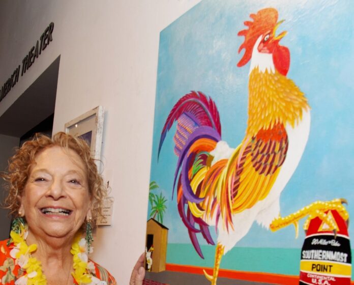 Marsha 2025 auction CT a woman standing in front of a painting of a rooster