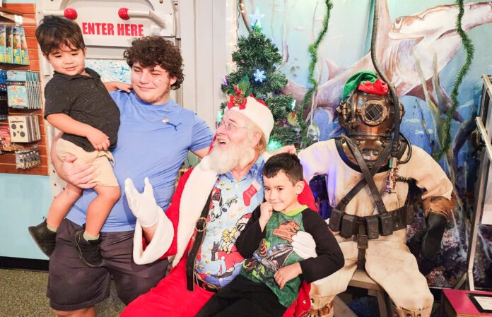 Merry Divemas a group of people posing for a picture