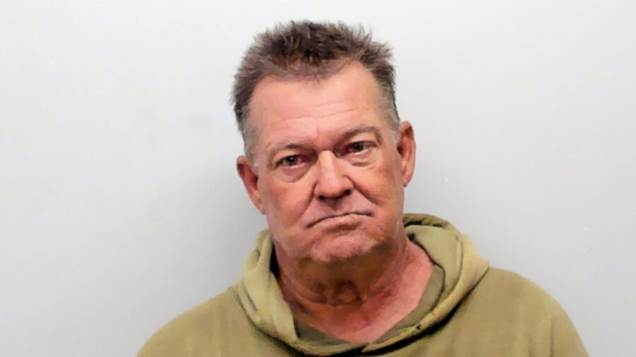 a man in a hoodie is looking at the camera